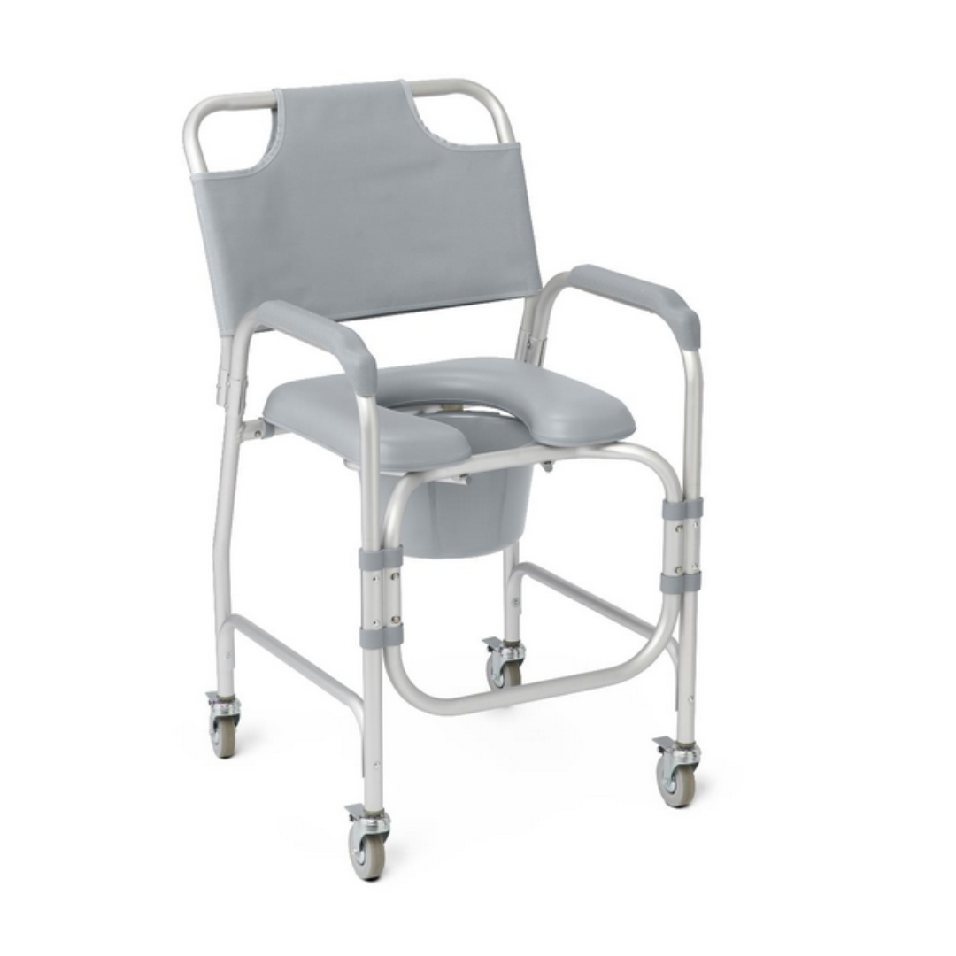 The Medline Drop-Arm Bedside Commode with Wheels & Padded Seat is gray, features a cut-out seat, padded armrests and backrest, and a removable bucket. Its drop-arm design facilitates easy transfers, ideal for mobility support and personal hygiene needs.